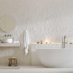 Weißes, modernes Badezimmer mit Badewanne, Waschbecken und Spiegel